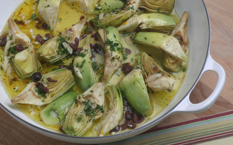 Artichokes braised with saffron, black olives and almonds