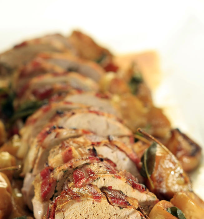 Bacon-wrapped pork loin with roasted apples