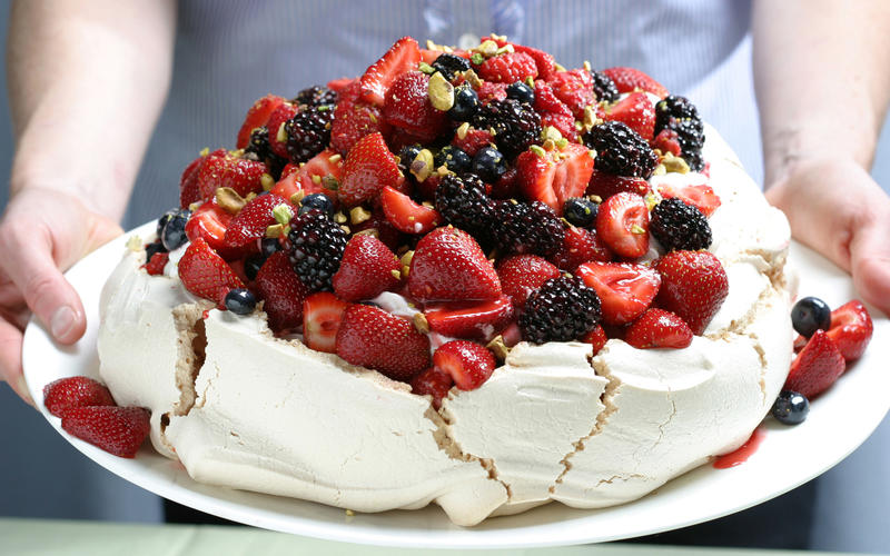 Berry Pavlova with vanilla whipped cream and pistachios
