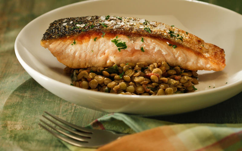 Crisp-skinned salmon with lentils, bacon and dandelion greens