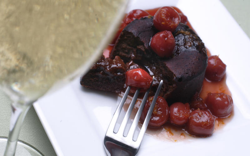 Flaming cherries over individual chocolate cakes