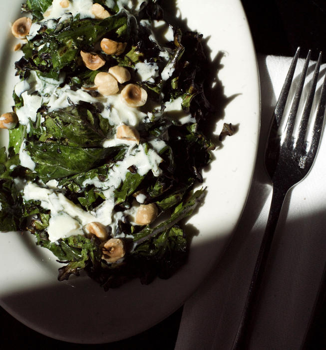 Grilled Russian kale with yogurt dressing and toasted hazelnuts