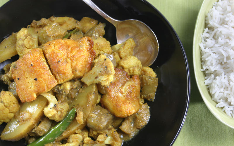 Maacher jhol (Bengali fish curry with eggplant, cauliflower and potato)