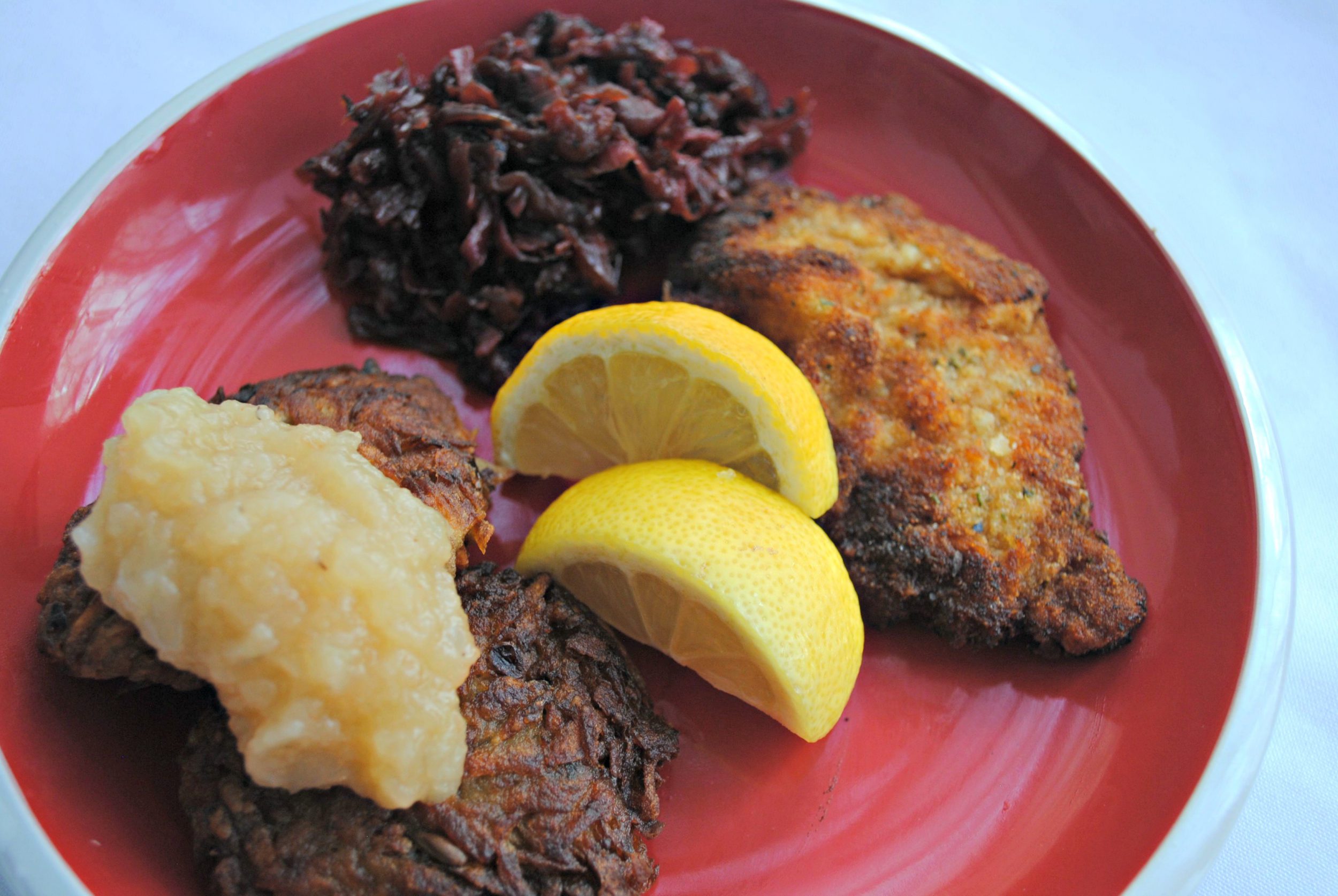 Pork and Veal Schnitzels with Red Cabbage, Apple Sauce and Potato Pancakes