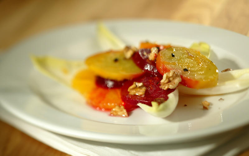 Red and golden beets with oranges, endive and walnuts