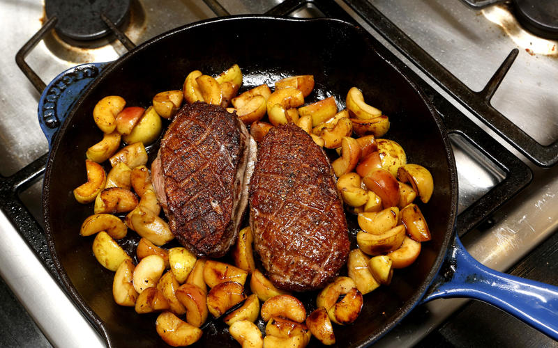 Sauteed duck breasts with apple and tart greens