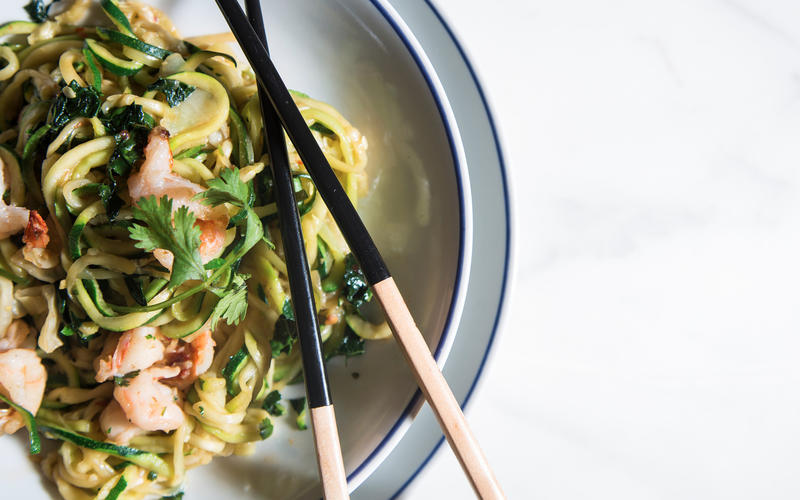 Stir-fried zucchini noodles with greens, cabbage and shrimp