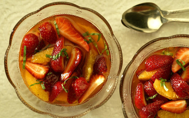 Strawberries and oranges in basil syrup