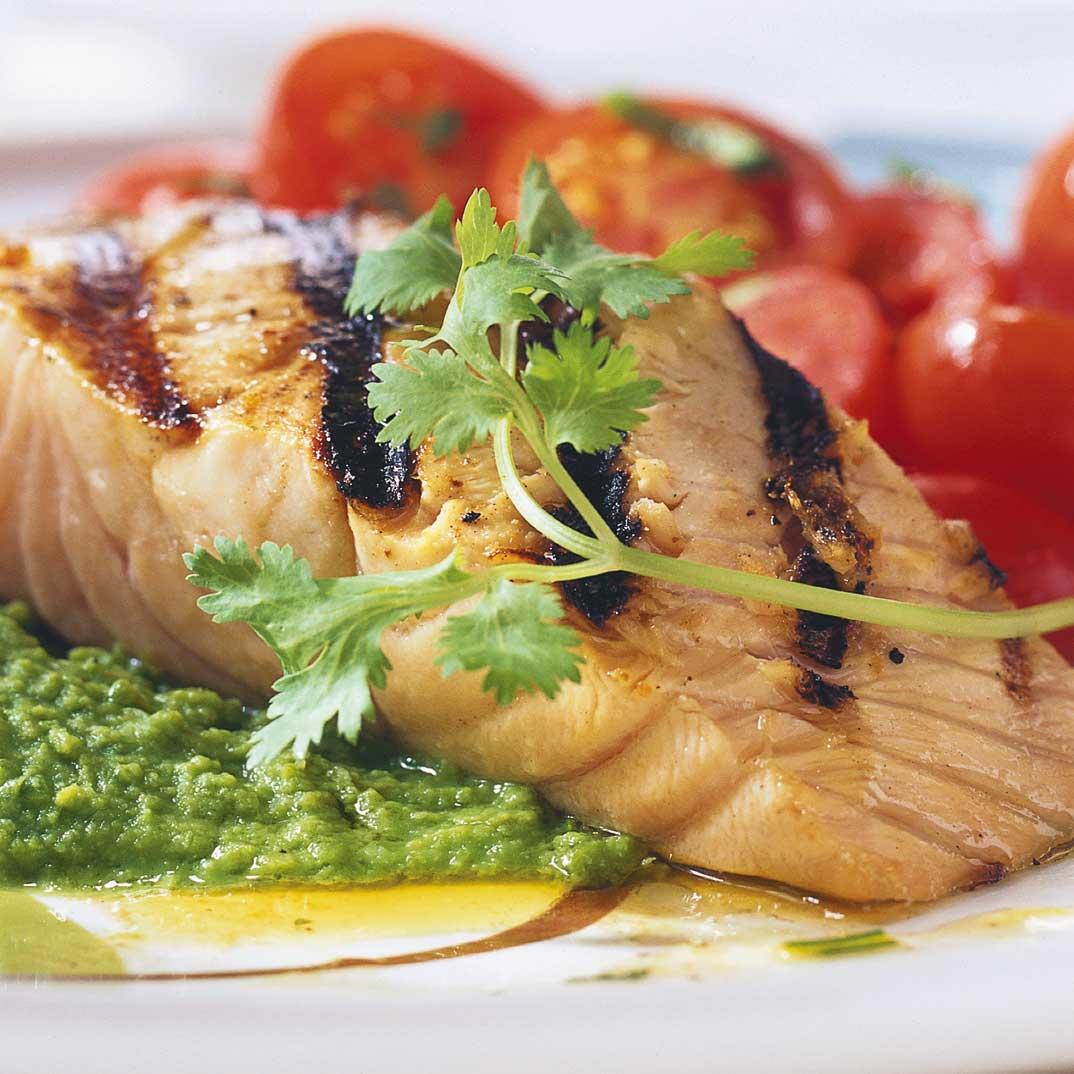 Grilled Salmon on Mashed Peas and Warm Cherry Tomato Salad 